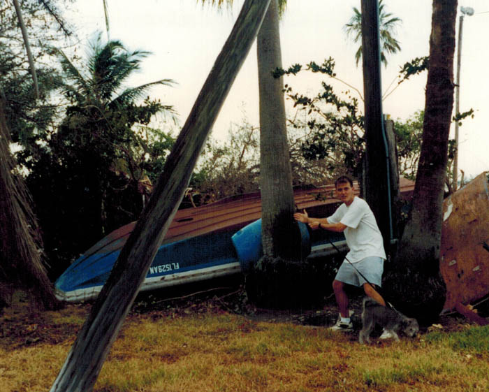 Eddie Stephens (with hair) surveying damage caused by Hurricane Andrew, August 28, 1992.